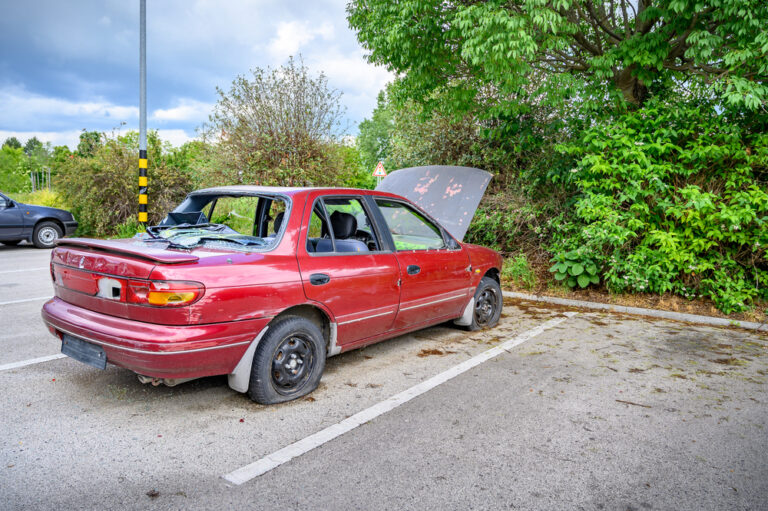 Destroyed,Abandoned,Car,With,Broken,Car,Glasses,,Flat,Tires,And